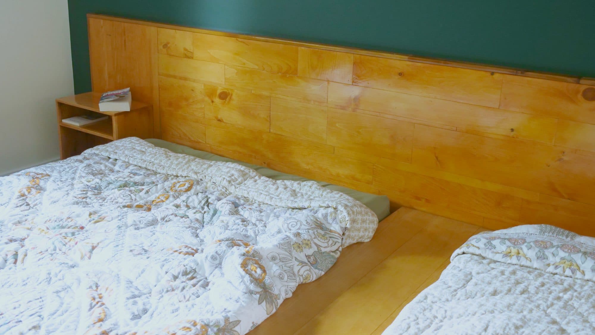 Plank headboard behind two beds