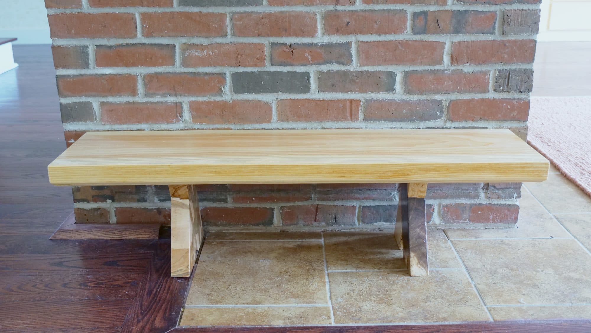 Pine hearth bench, front, on brick hearth