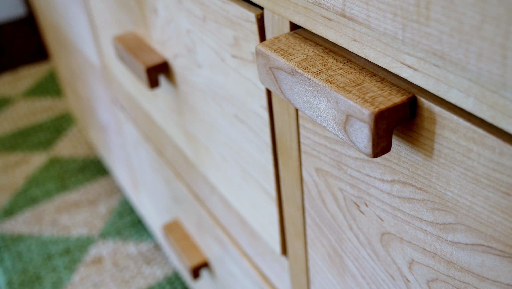 Carved wood drawer-pull detail