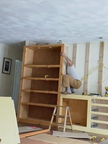 Installing tall bookcase (on ladder)