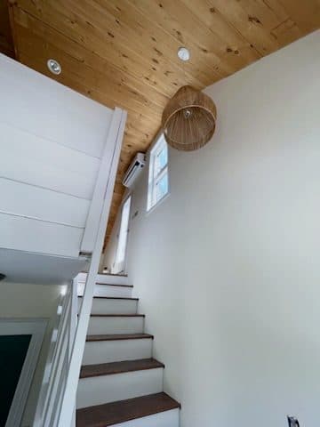 Finished stair, dark treads/white risers, looking up