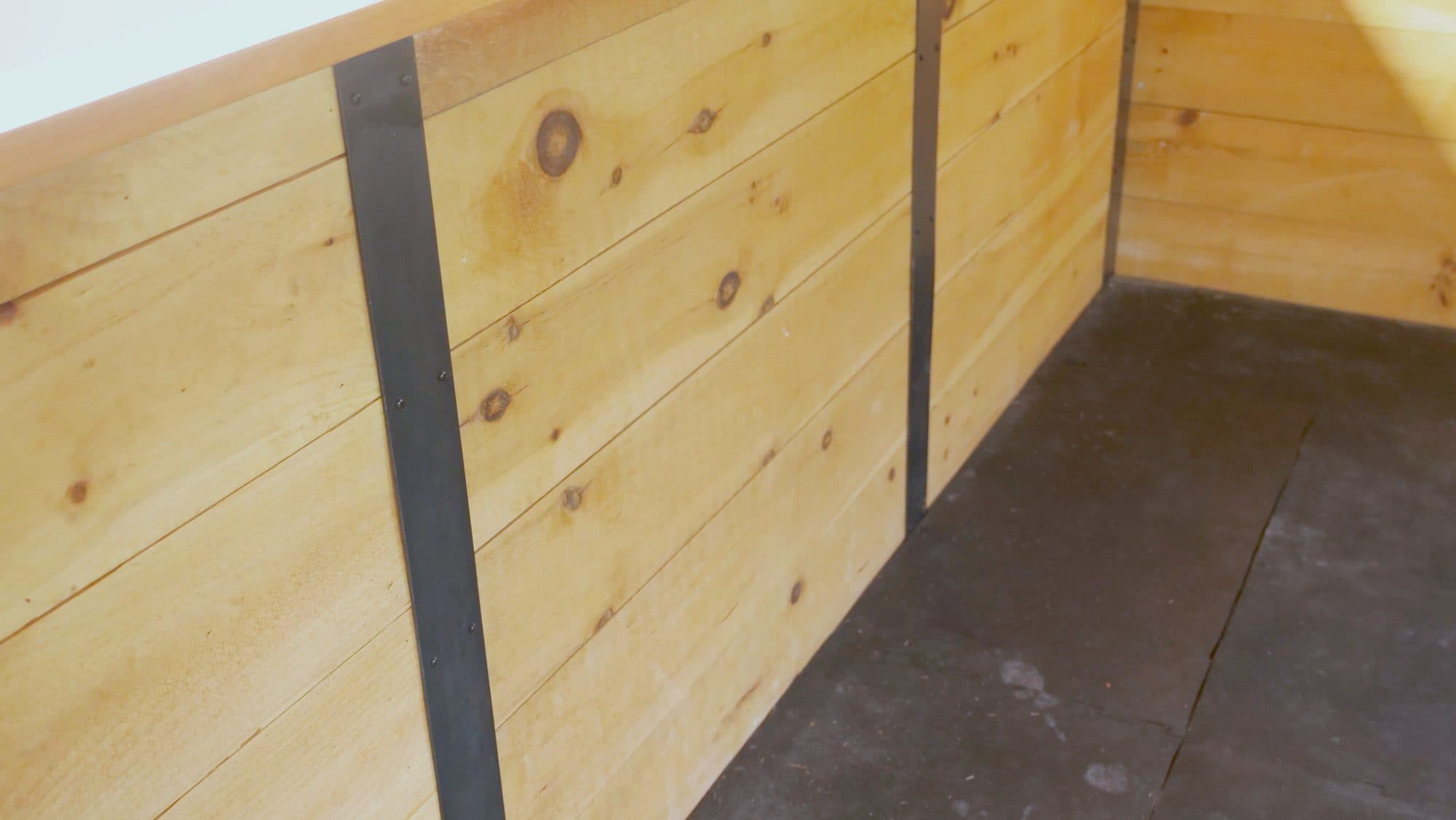 Pine knee-wall wainscot w/ black metal strap battens