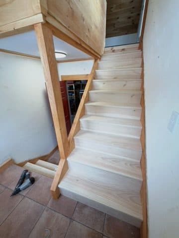 Newly installed bare treads/risers + newel