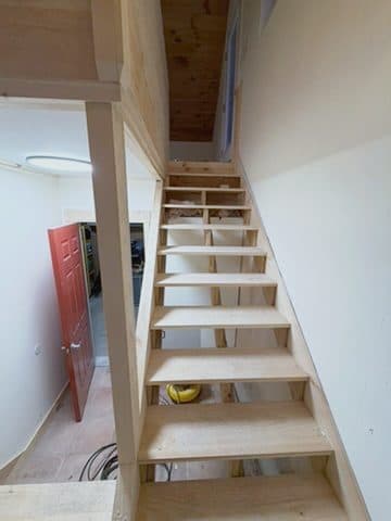 Treads in, open risers, newel mid-build