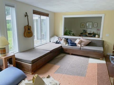 L-daybed, gray cushions, guitar wall